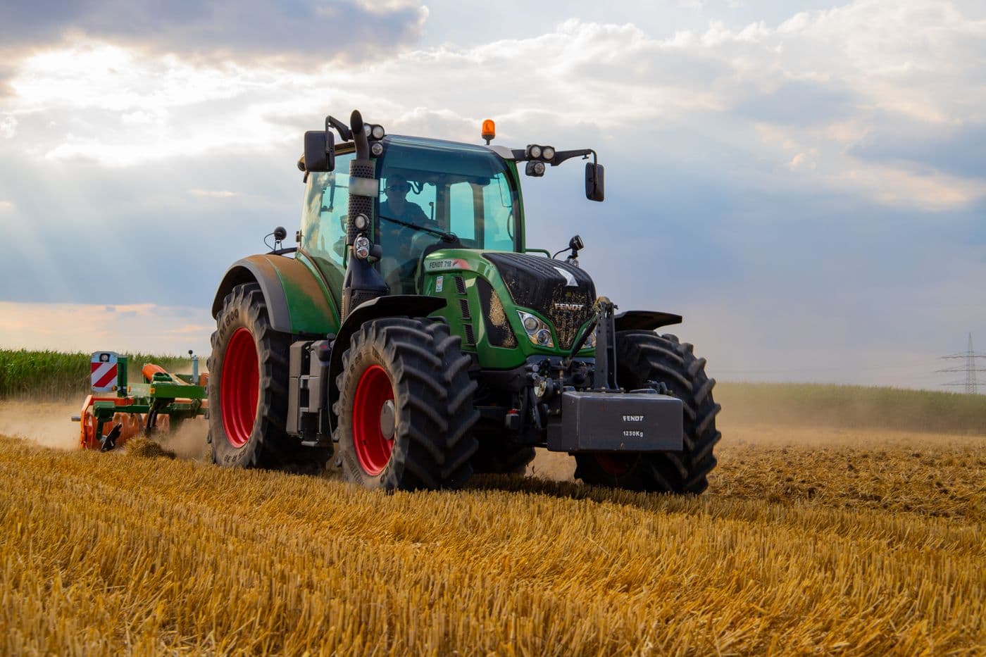 Tractor working a field during harvest